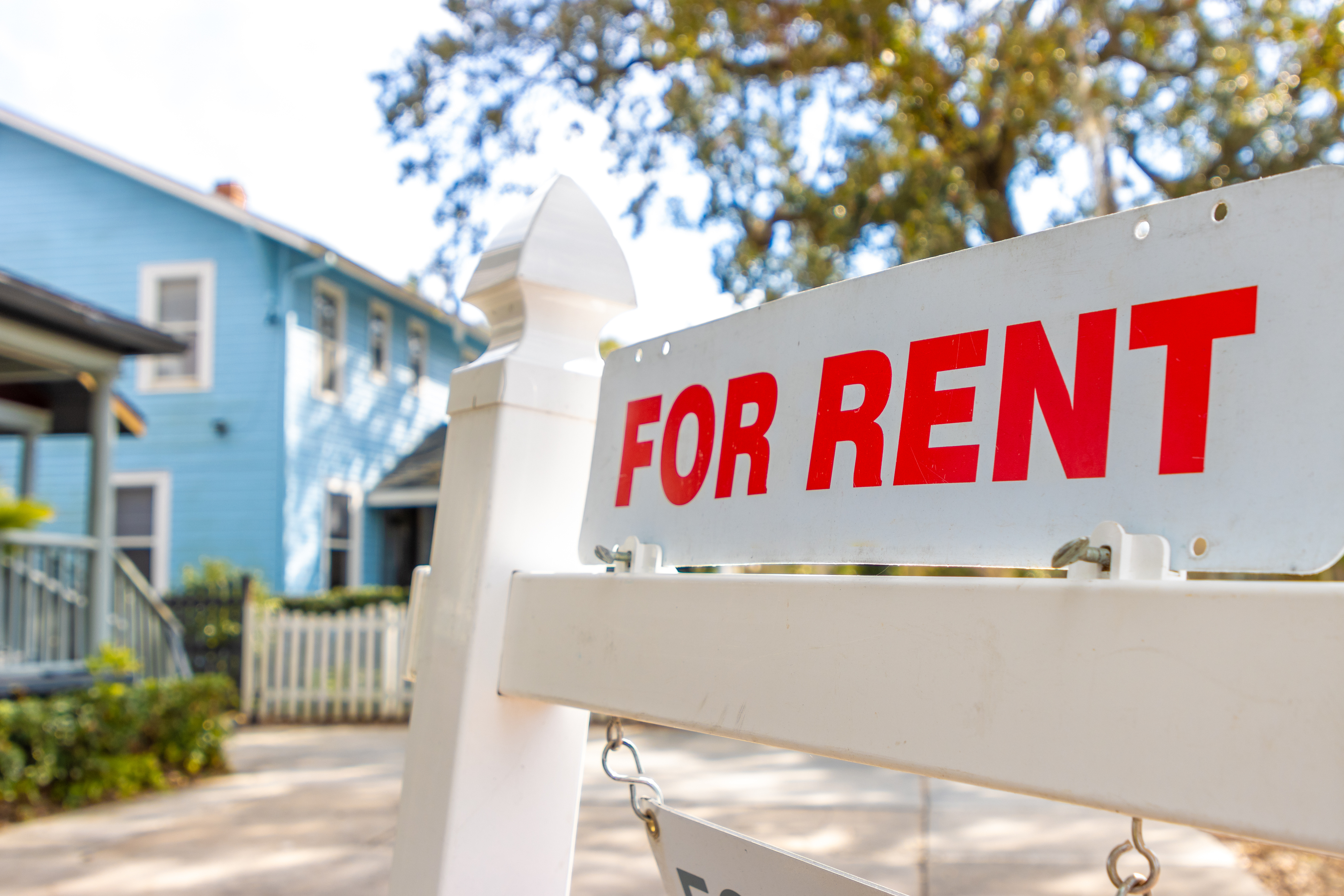 a for rent sign in a homes front yard