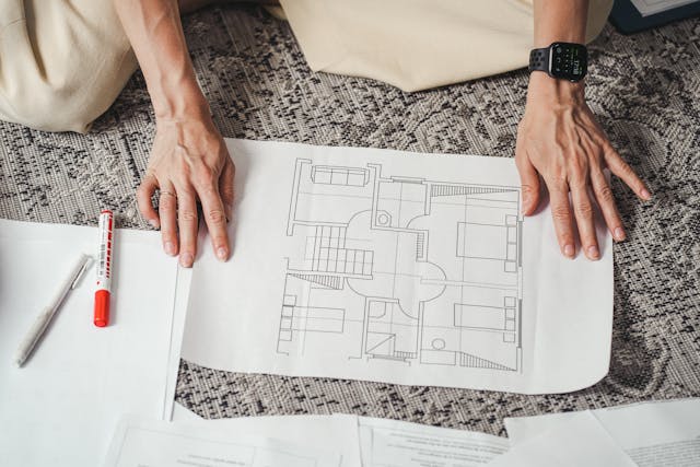 a person looking at a blueprint