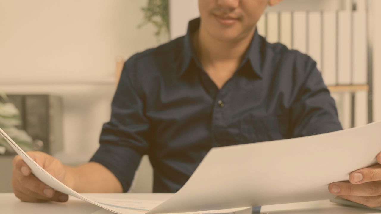 a person looking over a lease agreement