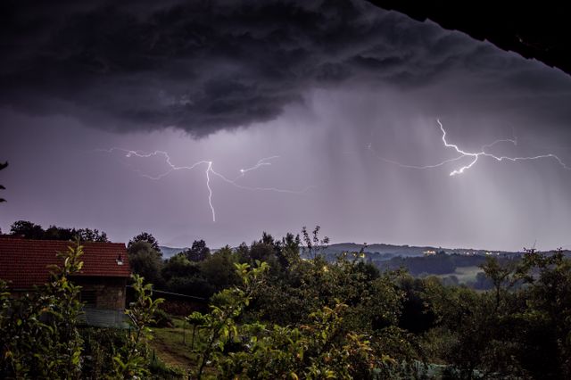 a thunderstorm over a rural landscape