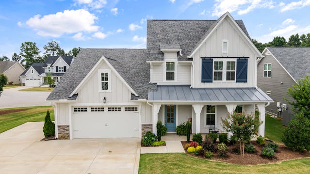 exterior of a home with a small front garden and trimmed lawn